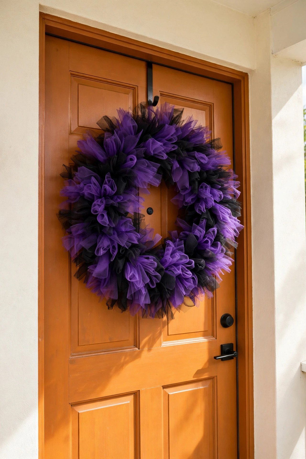 Halloween wreath of purple and black tulle strips looped in full fluffy sections