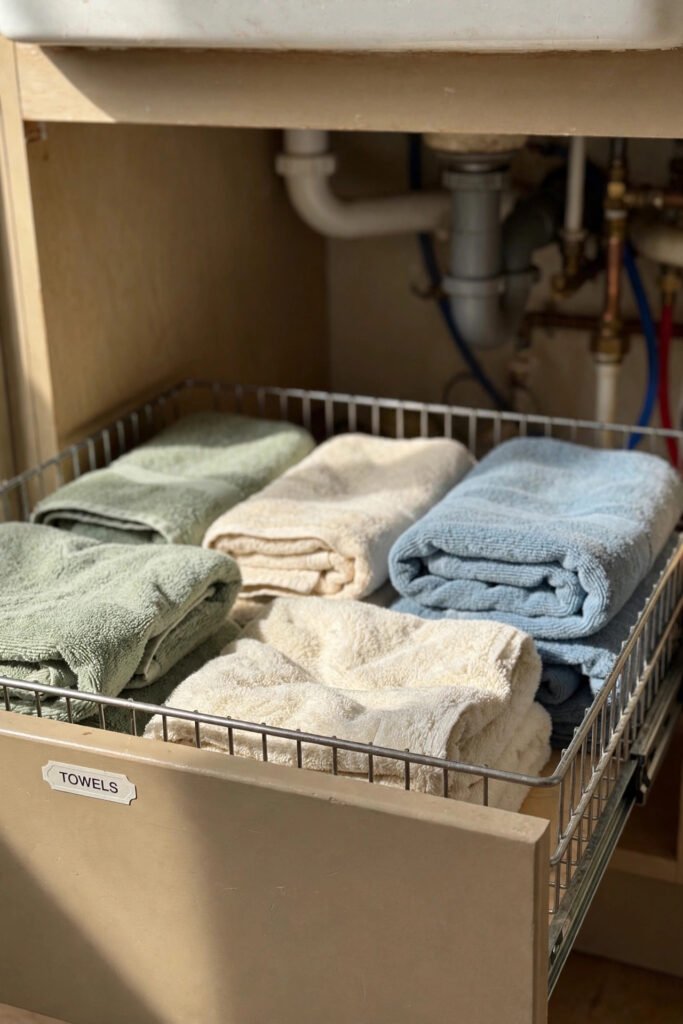 Pull-out drawer with folded towels under sink